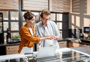 Man and woman managing business at the cafe or small shop