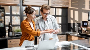 Man and woman managing business at the cafe or small shop