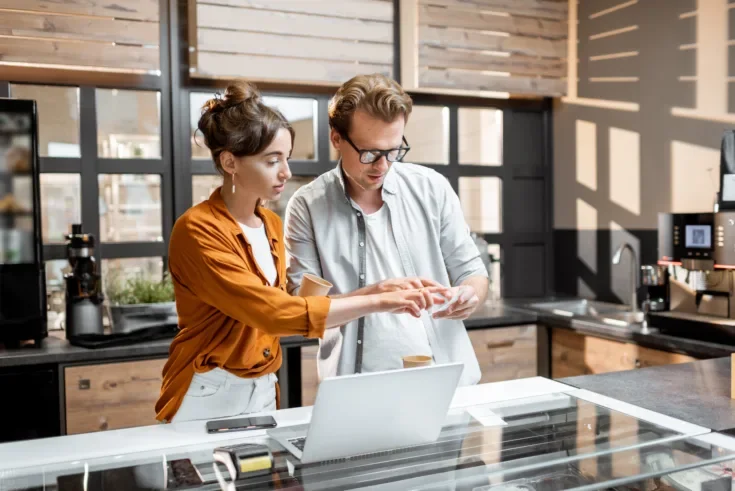 Man and woman managing business at the cafe or small shop