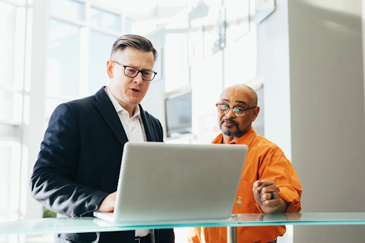 2 men looking at laptop