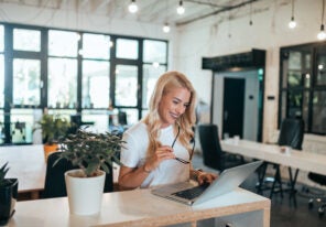 Successful female entrepreneur at work in modern open-space offi