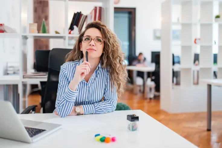 Thoughtful young businesswoman thinking of business problem solu