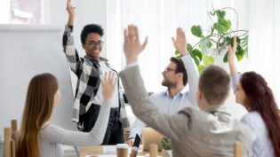 business people group raise hands at corporate presentation training