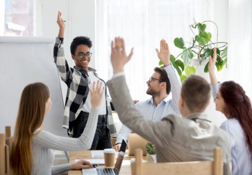 business people group raise hands at corporate presentation training