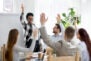 business people group raise hands at corporate presentation training