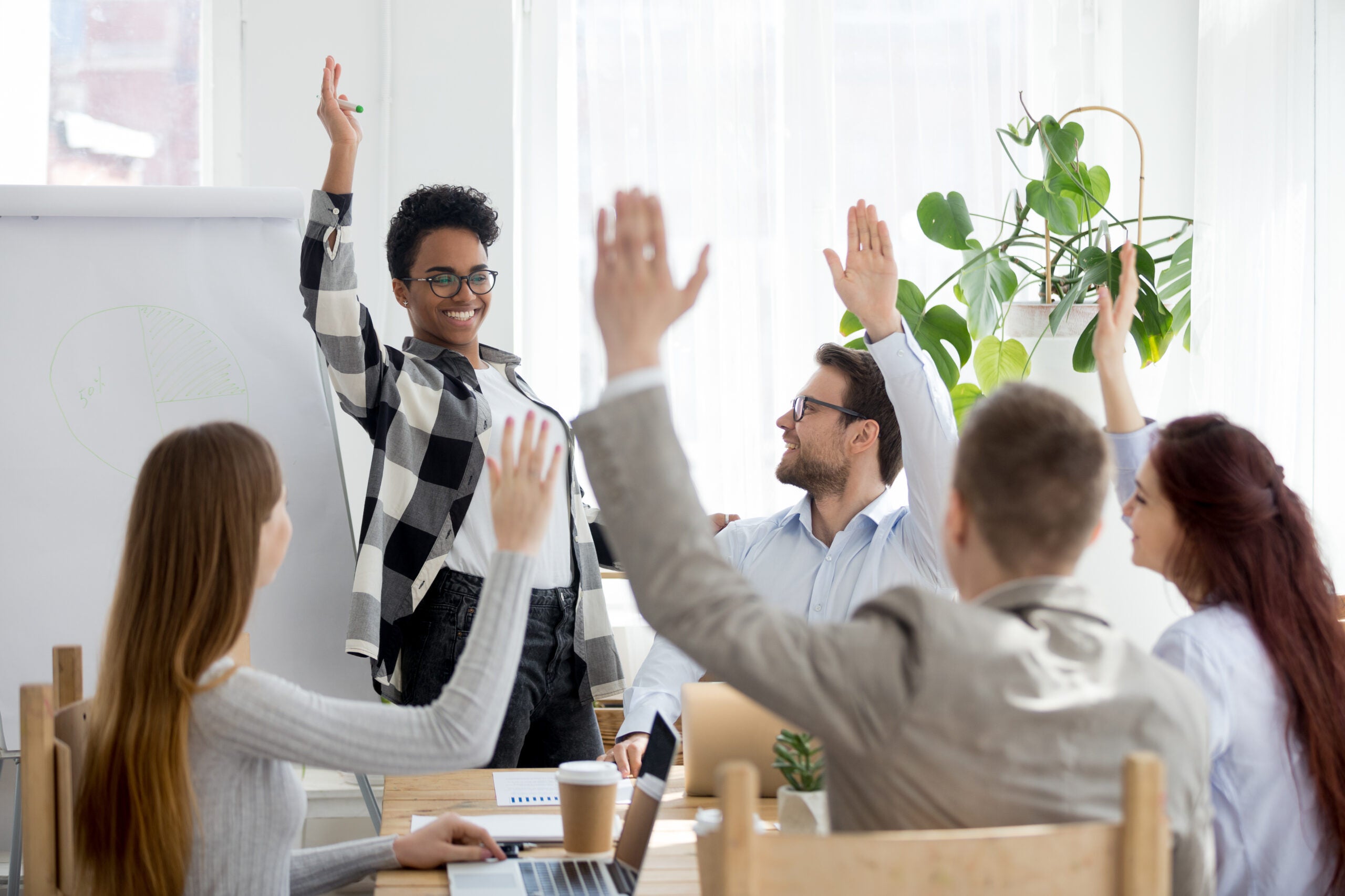 business people group raise hands at corporate presentation training