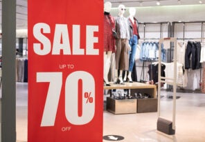 Big red sale 70% sign to draw attention of customer in front of women clothing store. Year of end or Black Friday sale period that department store has lots of discount for all products.