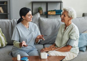 Young Nurse Talking to Senior Woman