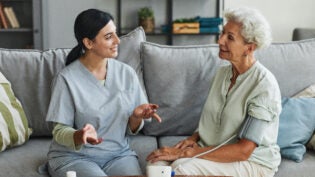 Young Nurse Talking to Senior Woman