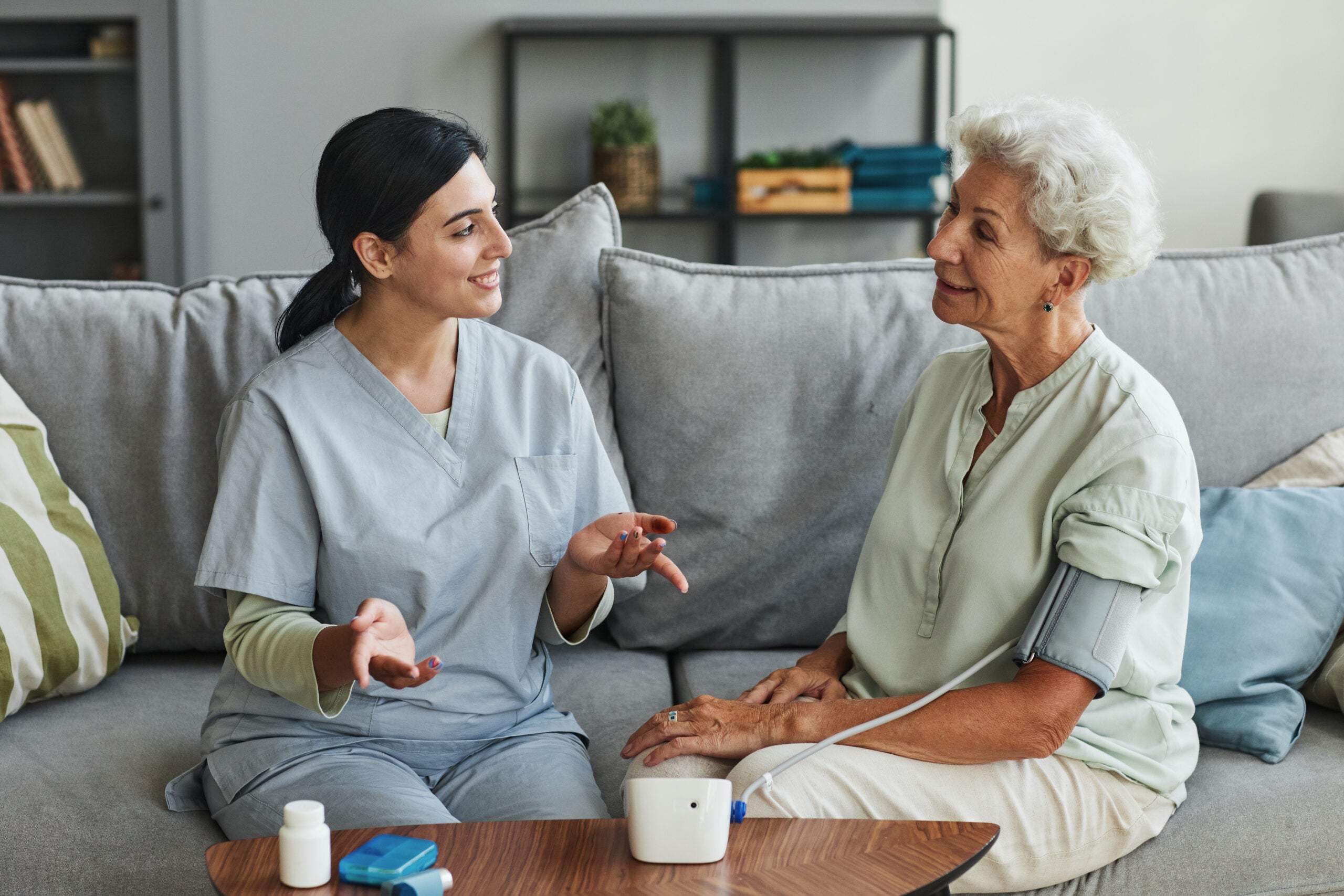 Young Nurse Talking to Senior Woman