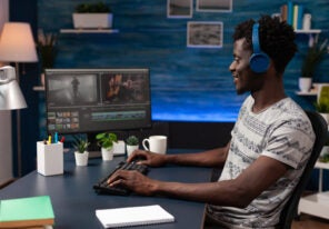 man editing movie footage on computer