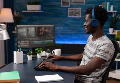 man editing movie footage on computer