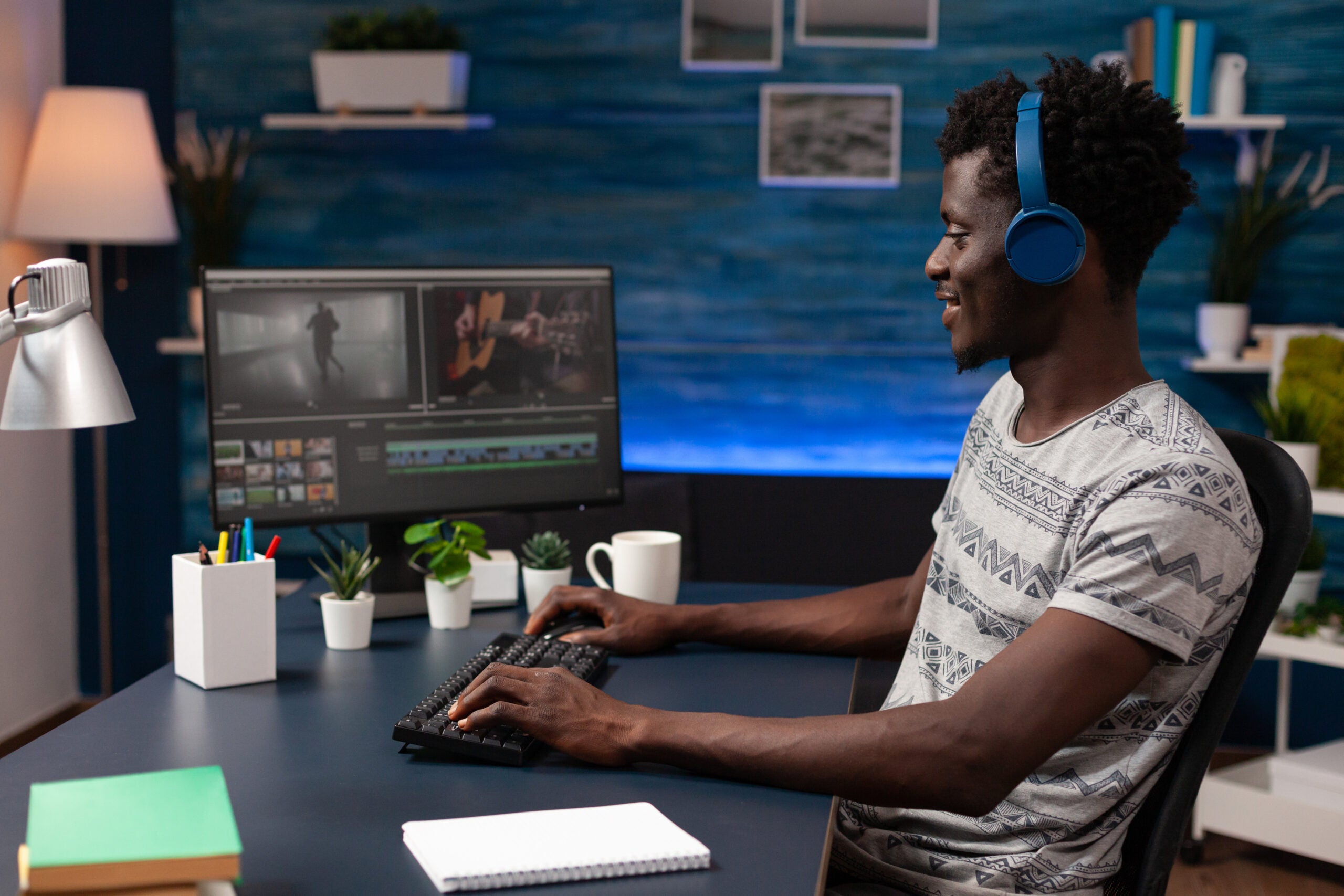 man editing movie footage on computer