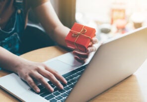 Woman hand holding red gift box about shopping online concept.