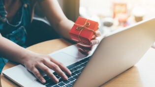 Woman hand holding red gift box about shopping online concept.