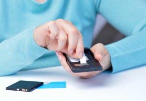 Woman hands putting the sim card on the phone