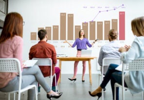 oung woman speaker reporting to the audience during the meeting in the conference room