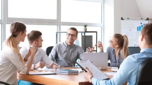 Group of young people at business meeting in office