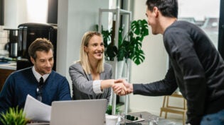 two financial advisors having a meeting with a male client