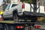 pickup vehicle accident transportation on flatbed tow truck machine on city street.