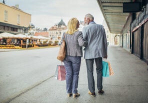 Senior couple carrying shopping bags and enjoying shopping