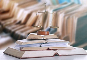 scales of justice on top of stack of books