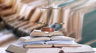 scales of justice on top of stack of books