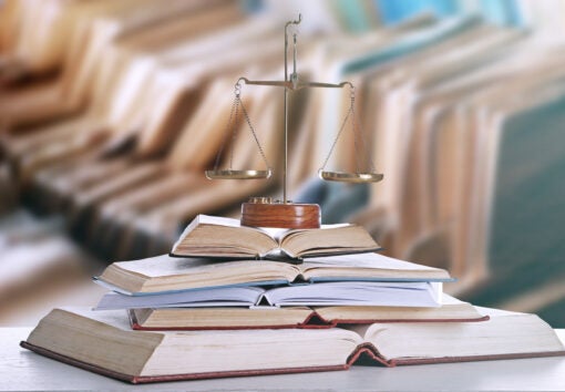 scales of justice on top of stack of books