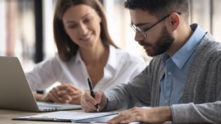 businessman signing partnership agreement