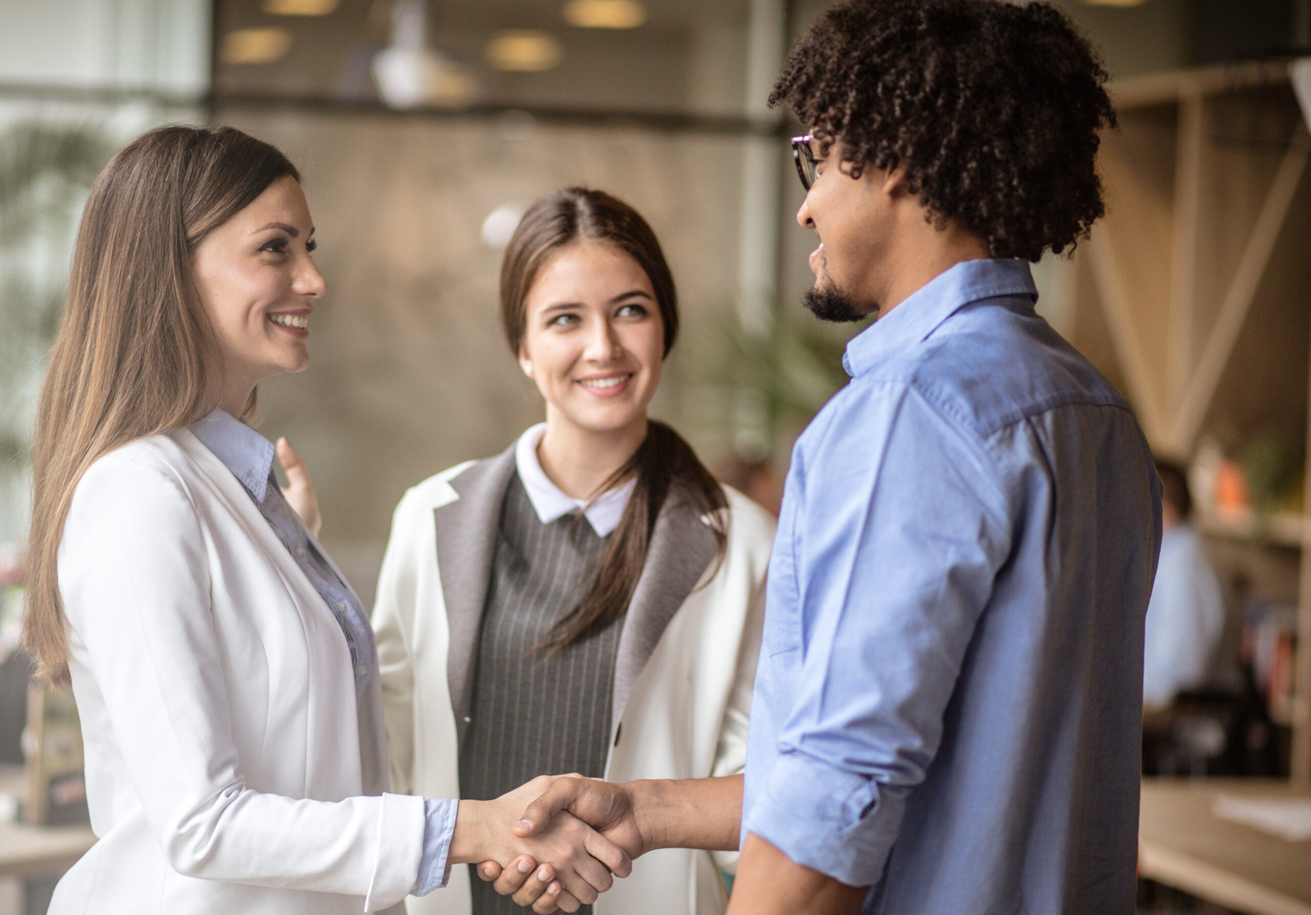 Business people shaking hands at office showing trust.