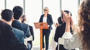 woman leading a conference