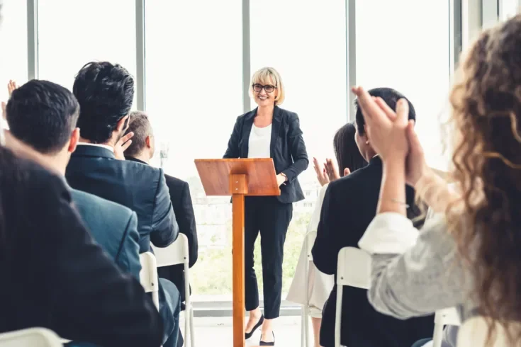 woman leading a conference