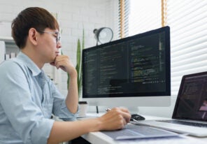 Male programmer read data code to thinking about developing website.