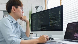 Male programmer read data code to thinking about developing website.