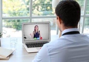 Young man having job interview online at home