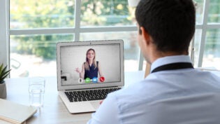 Young man having job interview online at home