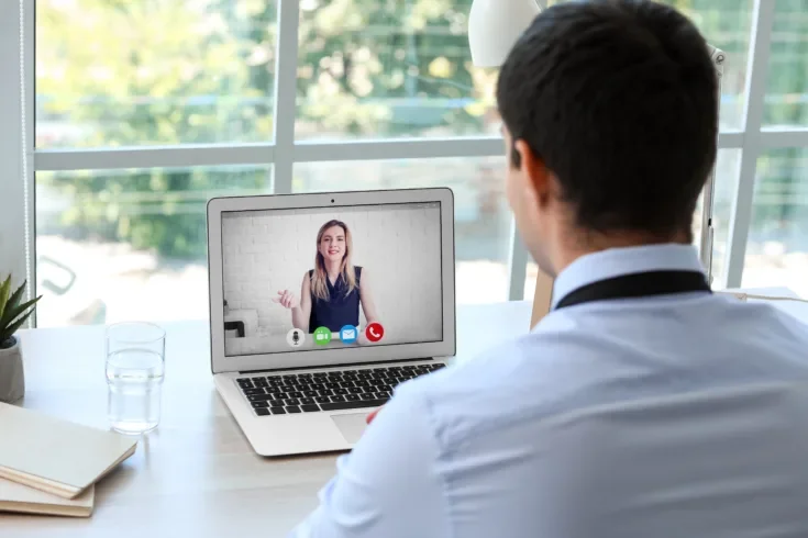 Young man having job interview online at home