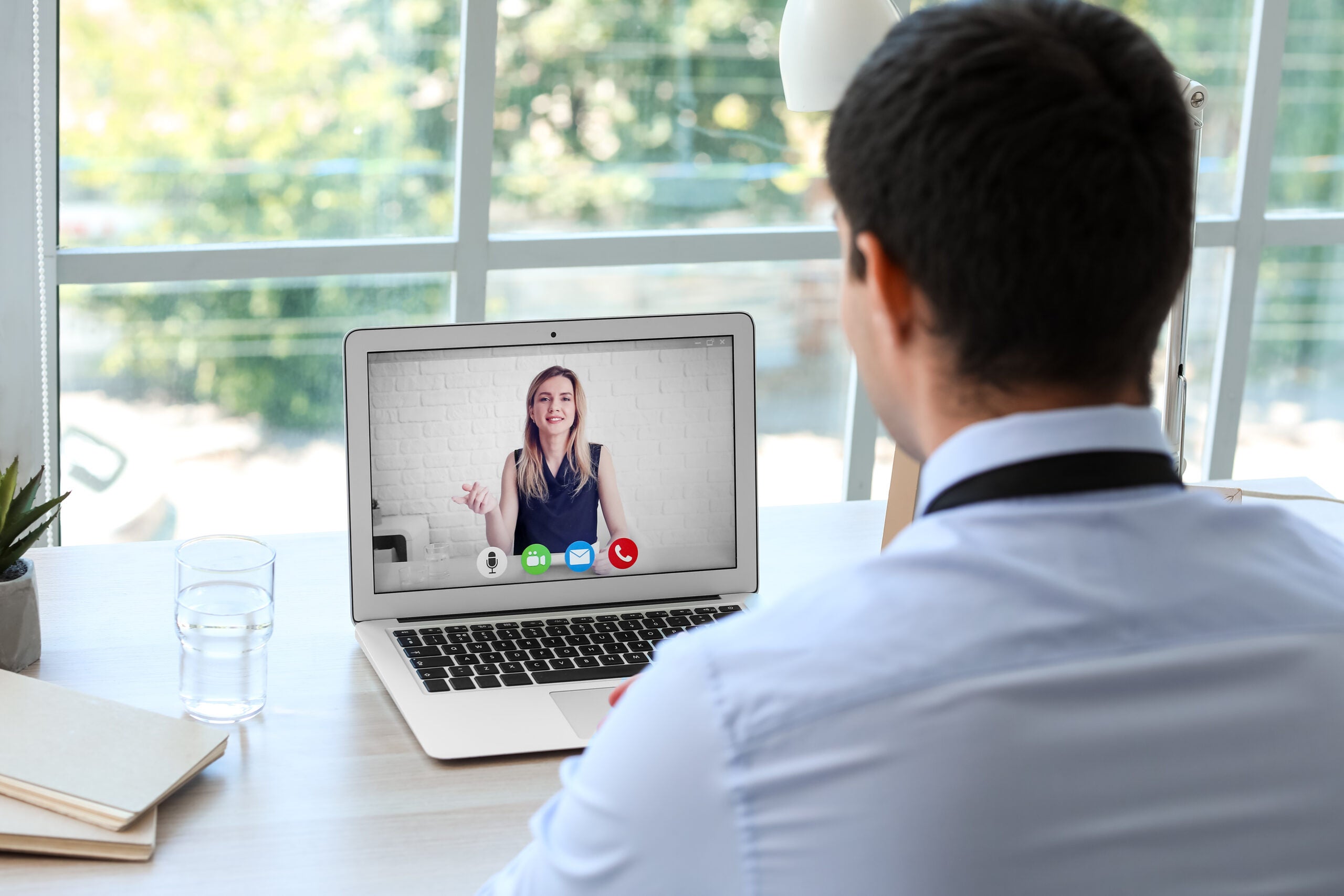 Young man having job interview online at home