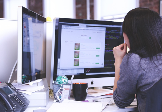 woman looking at content management system on a monitor