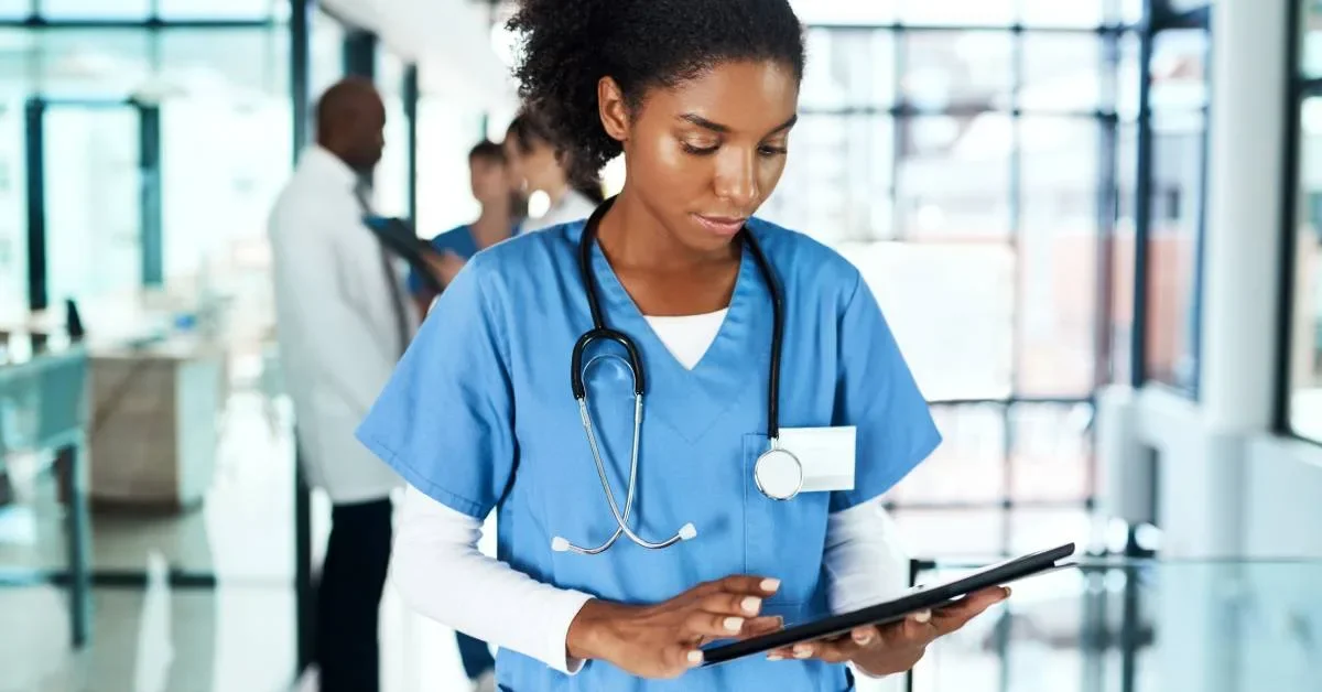 African American female healthcare worker checking chart