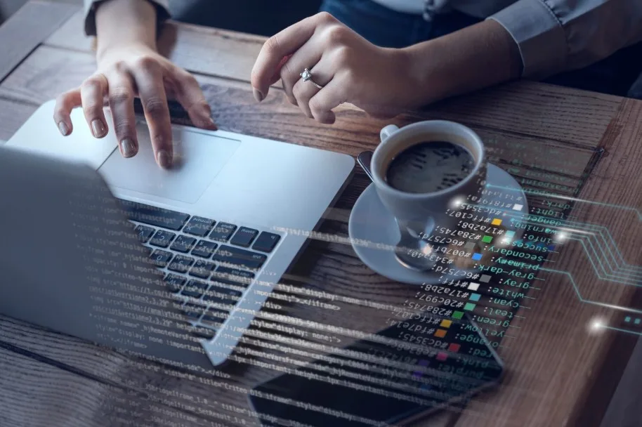 female hands typing on laptop