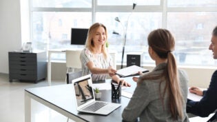 Human resources commission interviewing woman in office