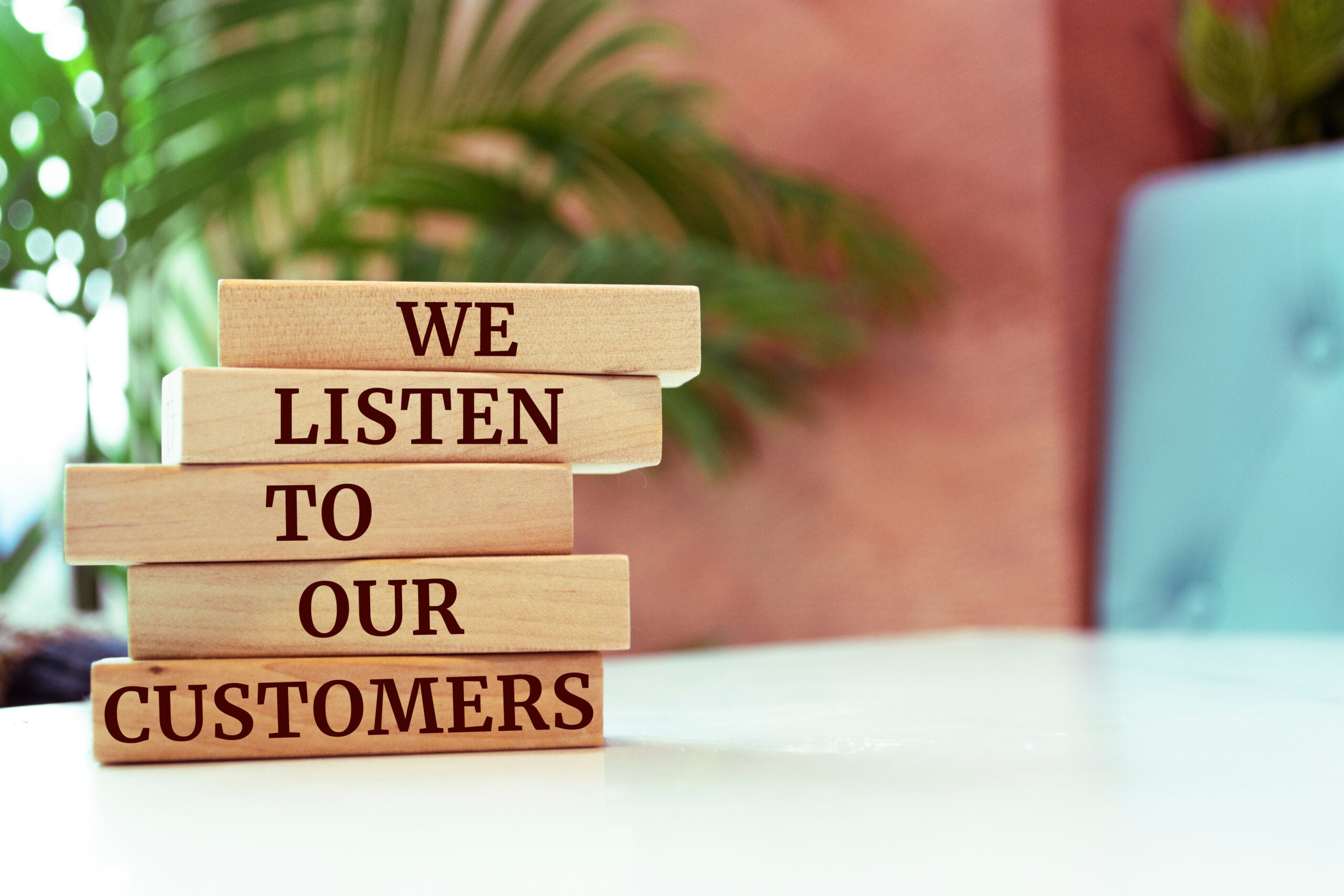 Wooden blocks with words 'We listen to our customers'. Business concept