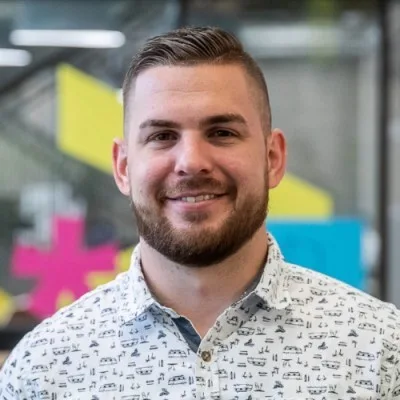 Headshot of man with beard in patterned shirt.