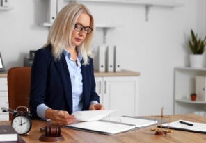 Mature female judge working with documents at table