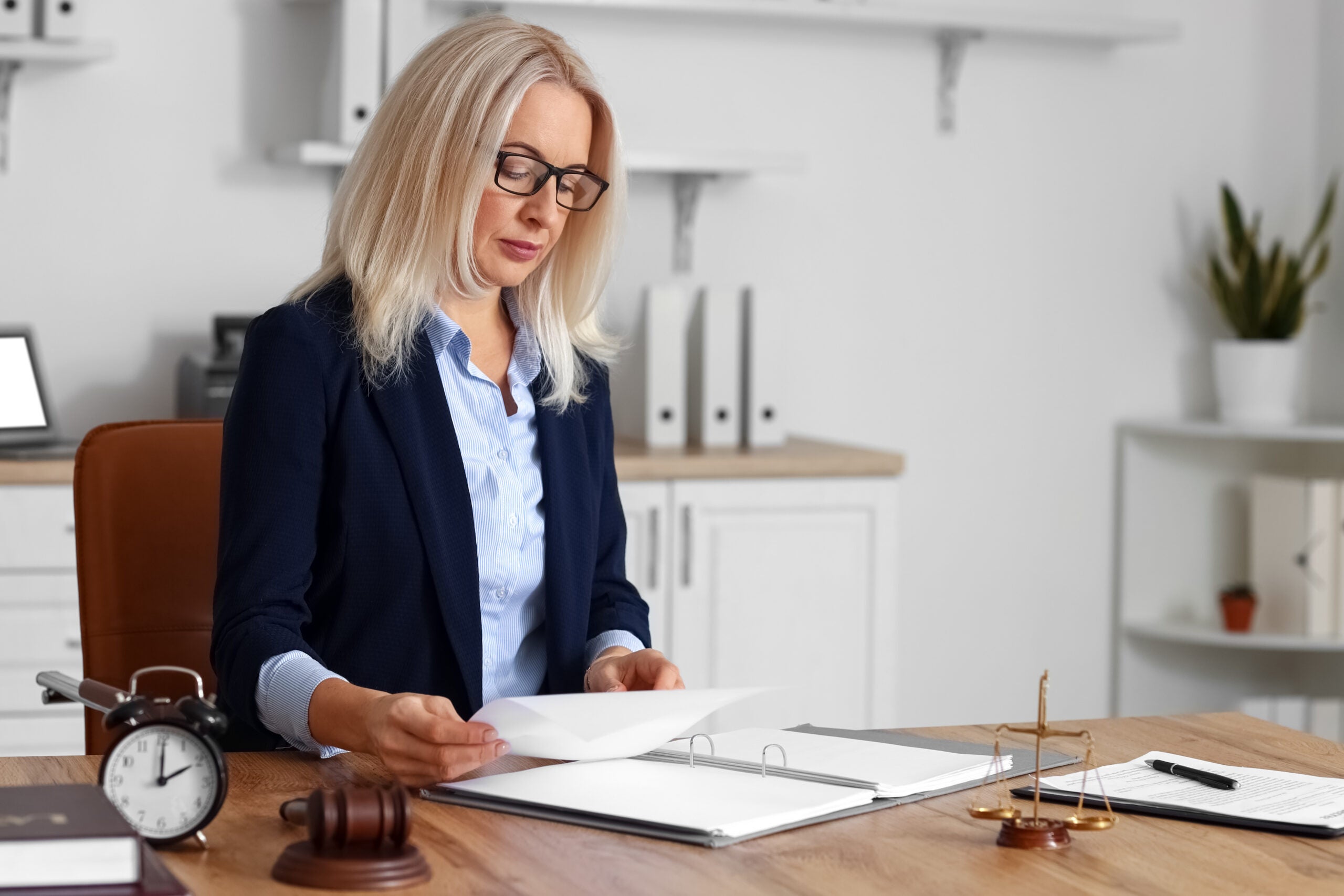 Mature female judge working with documents at table