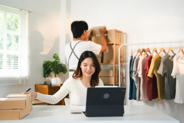 young woman in store working on laptop