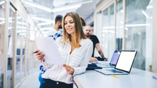 smiling female business trainer reading