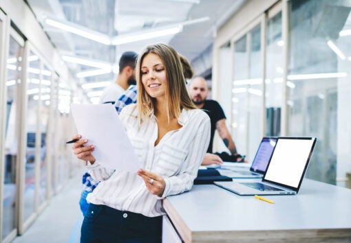 smiling female business trainer reading