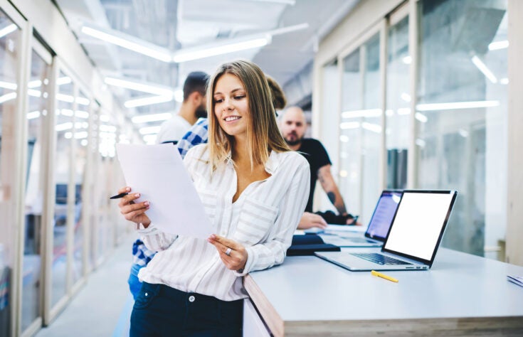 smiling female business trainer reading
